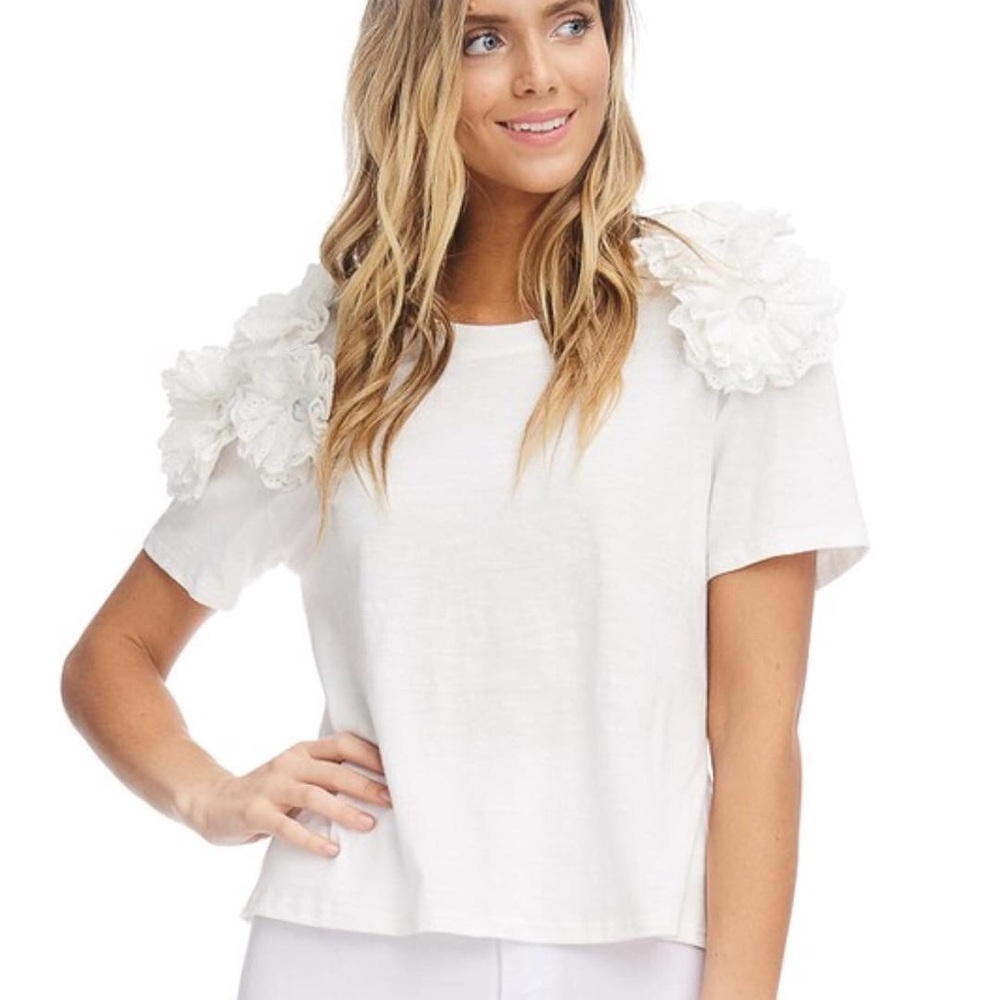 White cotton top with details on both shoulders.